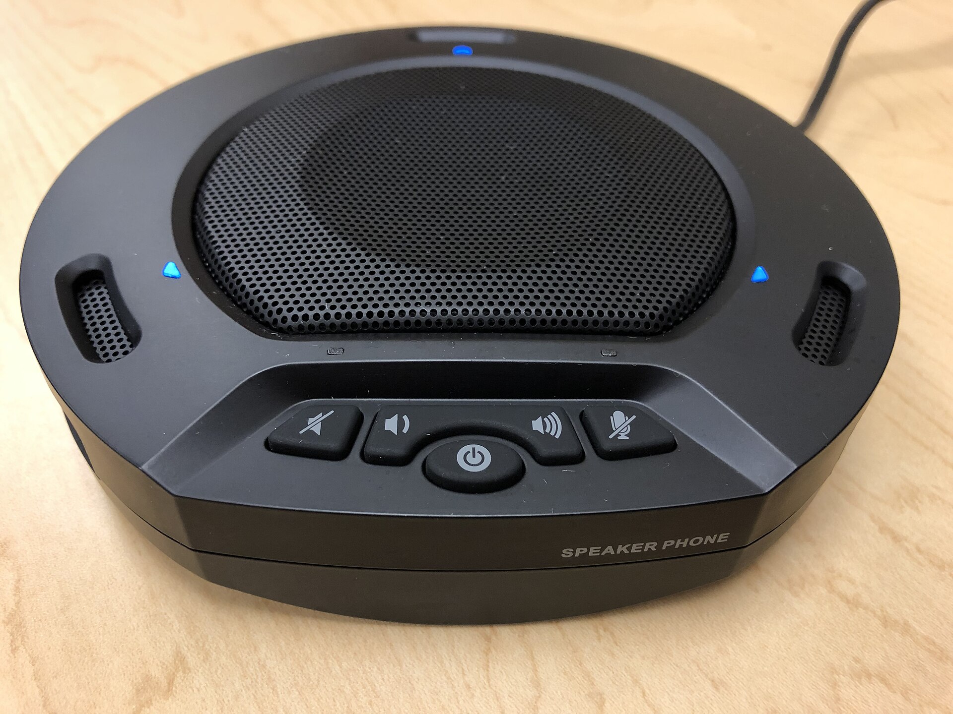 A conference speakerphone on a desk