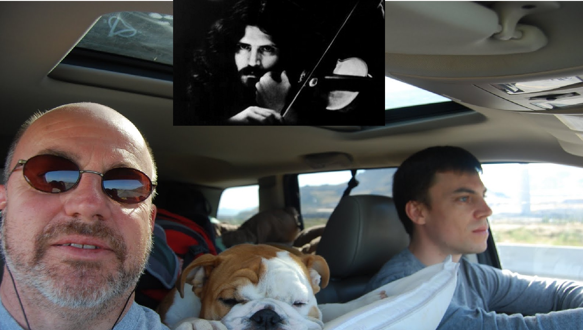 Selfie on a long drive: a man in sunglasses in the passenger seat, a bulldog asleep between the seats and a younger man driving, with an inset black-and-white photo of Robby Steinhardt of Kansas playing violin